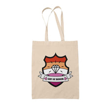 Load image into Gallery viewer, Natural coloured tote bag featuring a shield with a banner across it&#39;s front. Banner reads Gay of Honor. The background of the shield is the lesbian pride flag and there is a jewel icon in the centre.