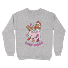 Load image into Gallery viewer, Heather Grey sweatshirt featuring retro text reading &#39;cosy vibes&#39;. The image shows a mug of hot chocolate with marshmallows and a gingerbread man wearing a Santa hat. A candy cane in the mug and lights around the mug are the colours of the lesbian pride flag.