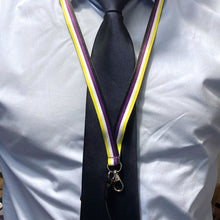 Load image into Gallery viewer, Person wearing a lanyard in the colours of the non binary flag over a shirt and tie.