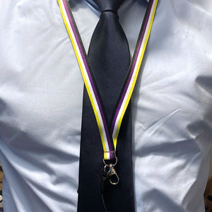 Person wearing a lanyard in the colours of the non binary flag over a shirt and tie.