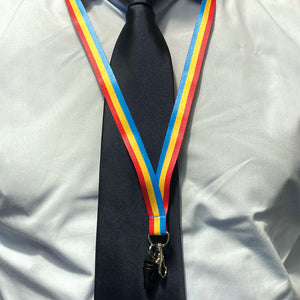 Person wearing a lanyard in the colours of the pansexual flag over a shirt and tie.