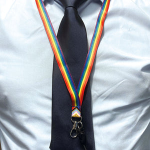 Person wearing a lanyard in the colours of the intersex inclusive progress flag over a shirt and tie.