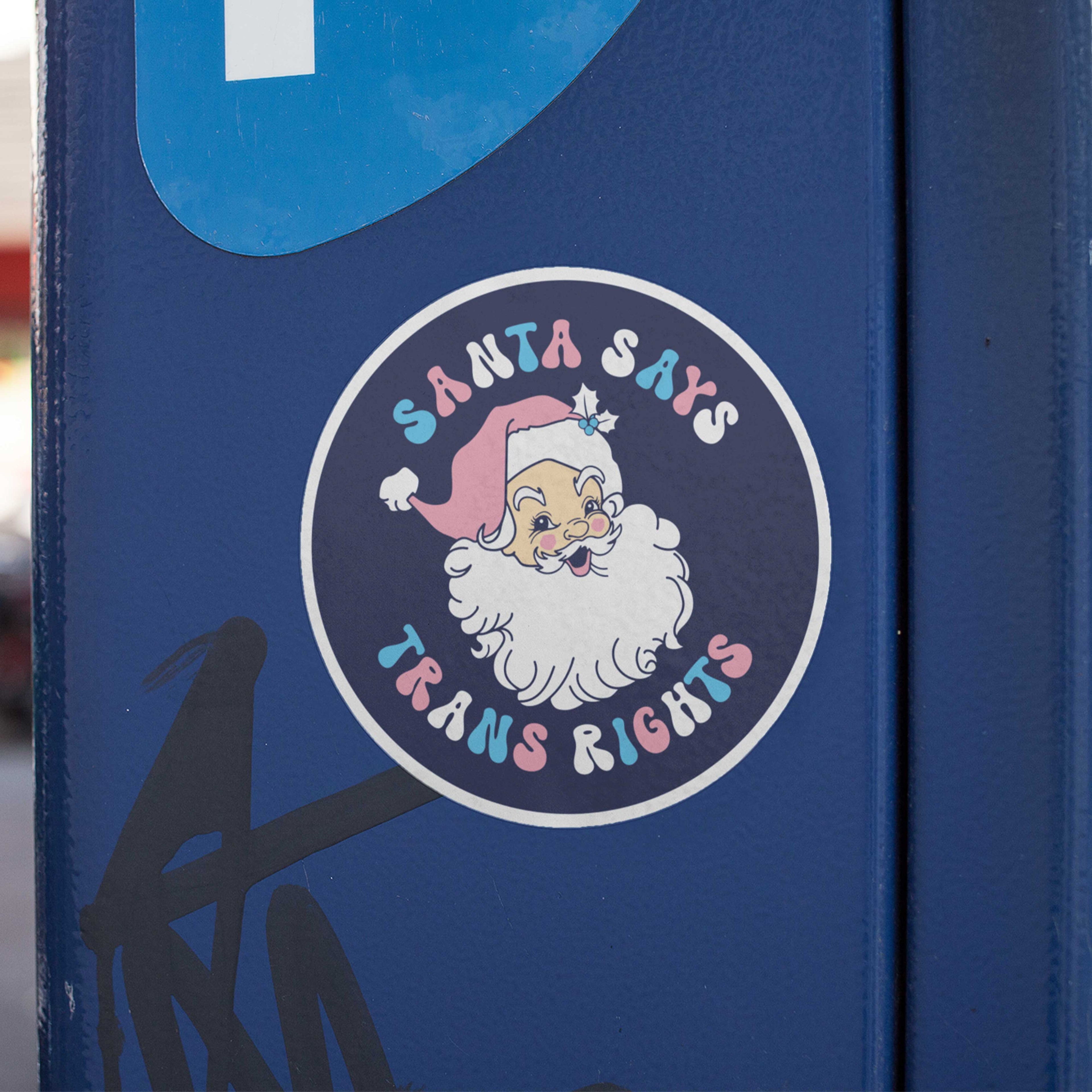 Santa Says Trans Rights Sticker stuck to a blue metal parking metre