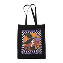 Load image into Gallery viewer, Black cotton tote bag featuring the slogan Witches for Trans Rights with an illustrated graphic of a witch with bats flying around her hat