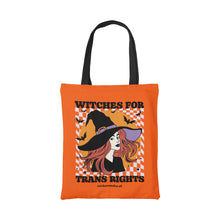 Load image into Gallery viewer, Orange cotton tote bag featuring the slogan Witches for Trans Rights with an illustrated graphic of a witch with bats flying around her hat