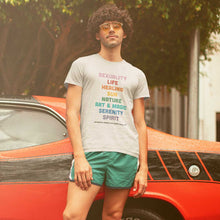 Load image into Gallery viewer, Retro style photograph of a man with dark curly hair wearing vintage style sunglasses. He is wearing a Gilbert Baker Original Pride Flag Retro Pride Shirt from Rainbow &amp; Co