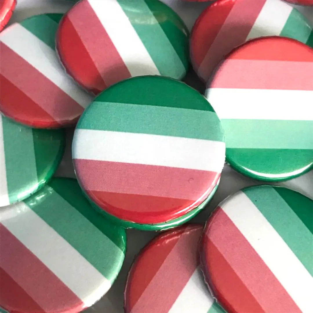 A pile of abrosexual flag badges