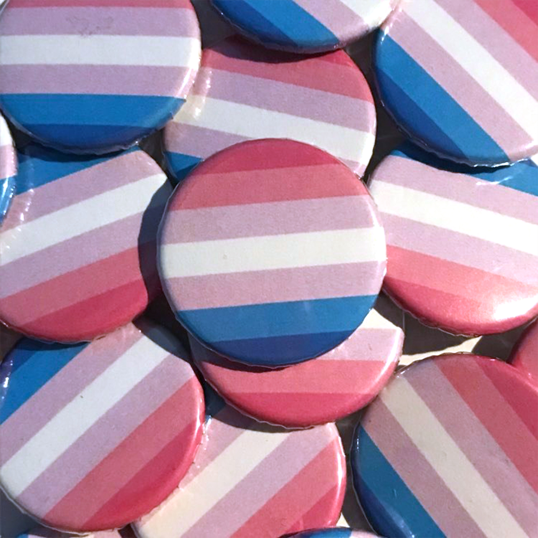 A pile of bigender flag badges