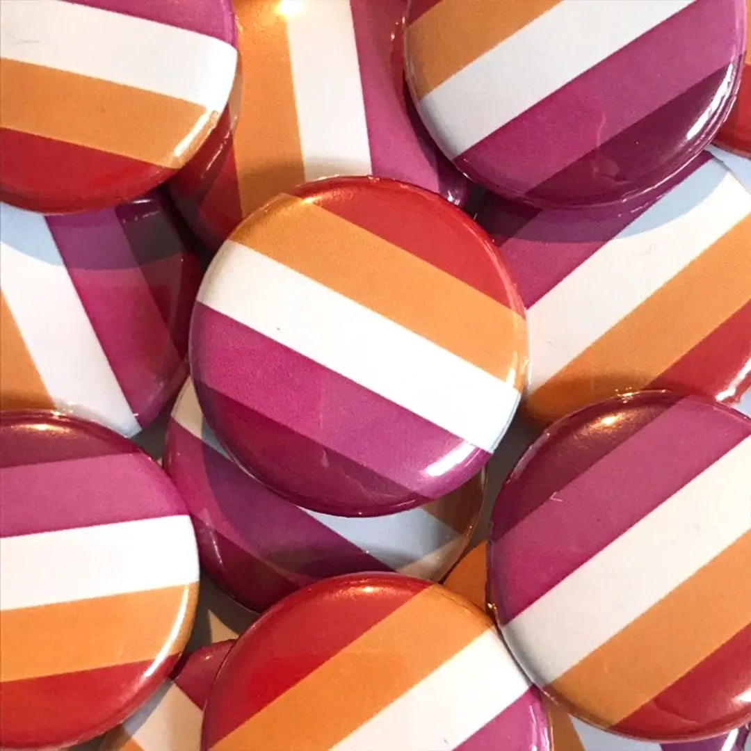 A pile of lesbian flag badges