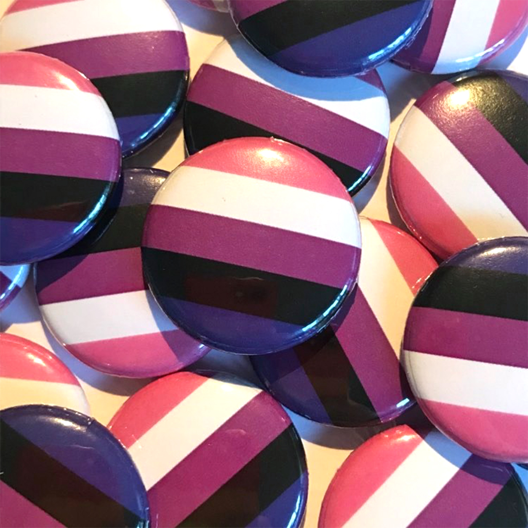 A pile of genderfluid flag badges