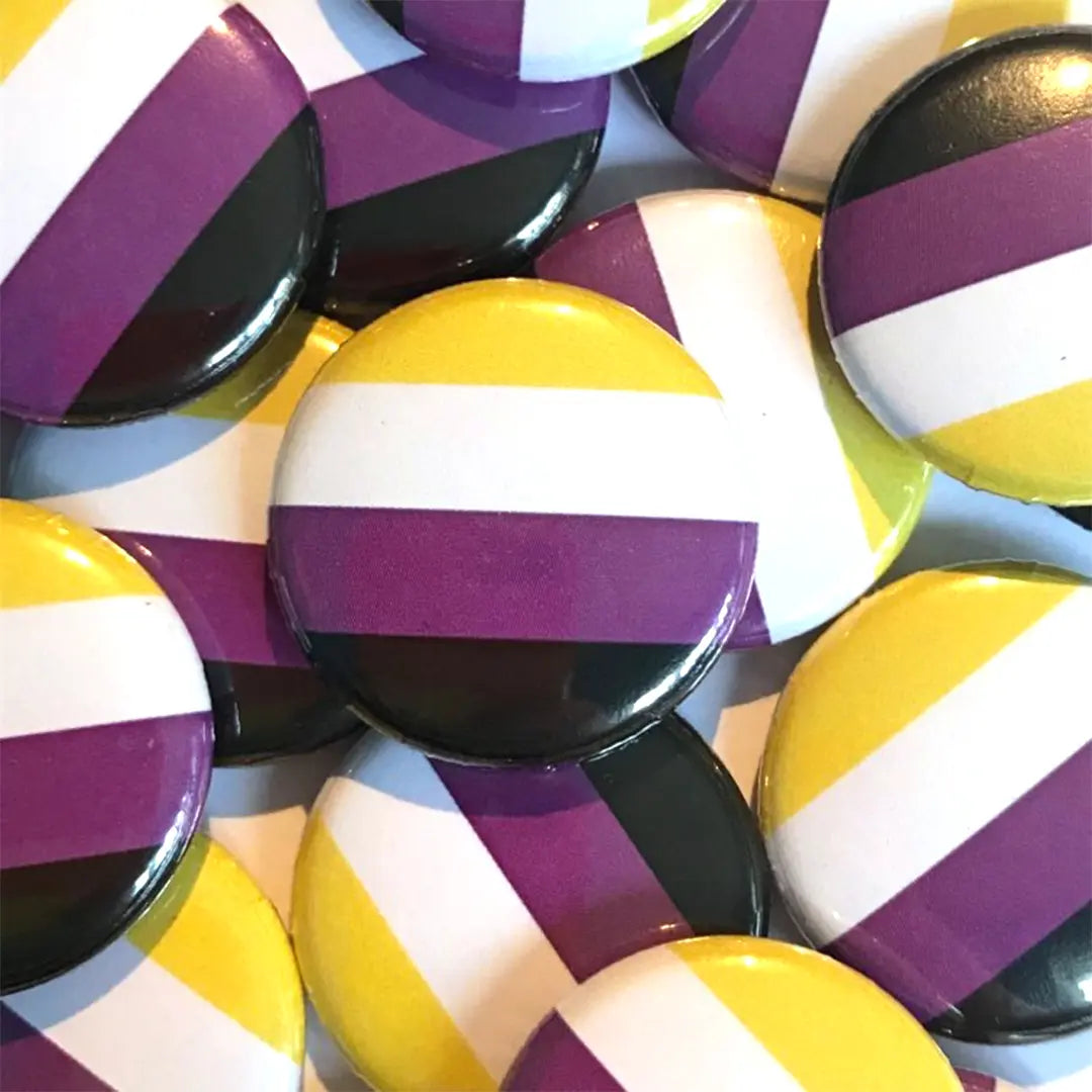A pile of non binary flag badges