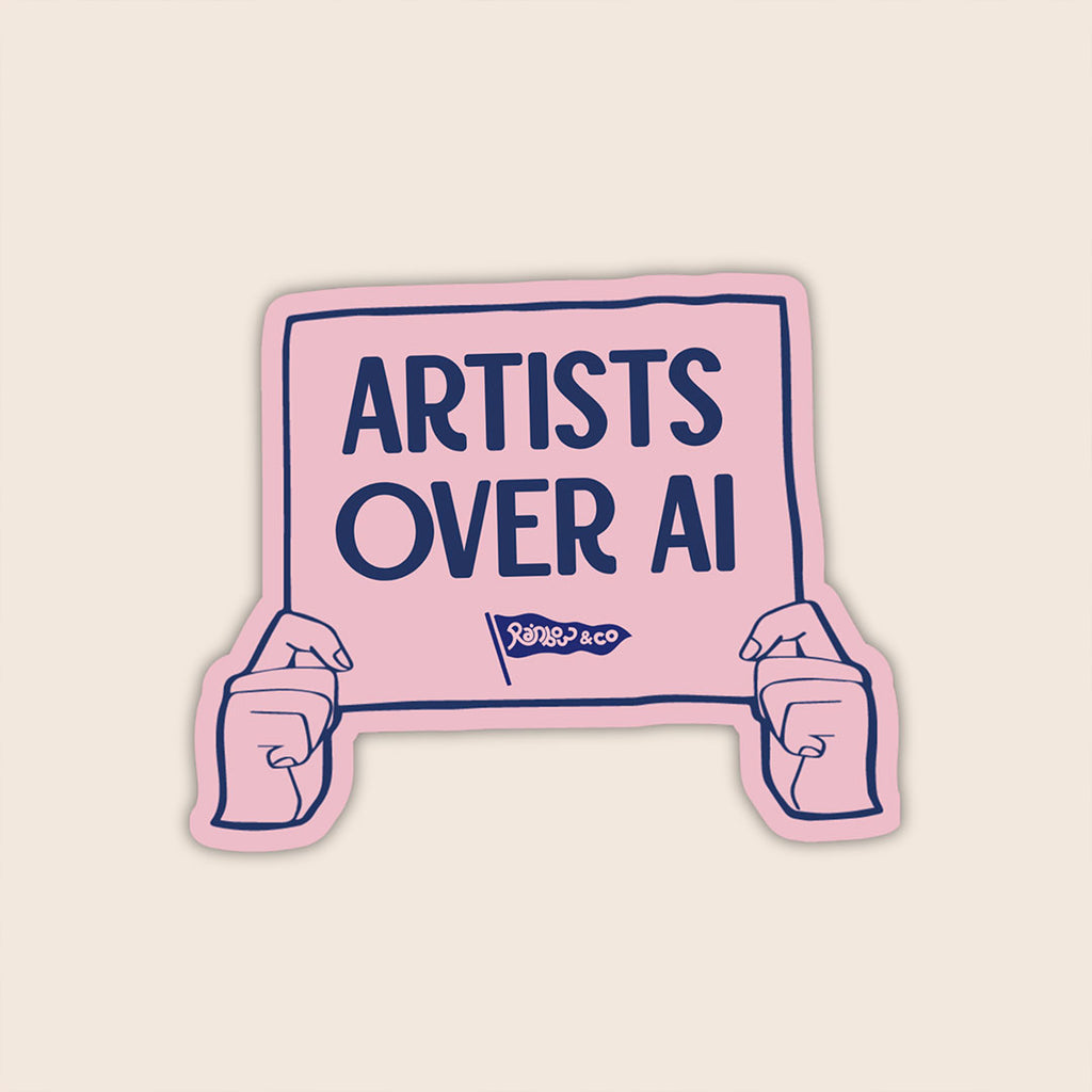 Artists Over AI vinyl sticker featuring illustrated hands holding a pink protest sign with the words "Artists Over AI".