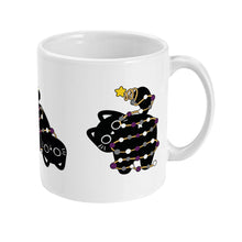 Load image into Gallery viewer, Right side view of a white ceramic mug displaying the black cat in a curled pose, wrapped in Christmas lights with asexual pride colours. The star-topped cat&#39;s tail is up in a playful manner.