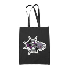 Load image into Gallery viewer, A black tote bag featuring a cute cartoon spider in front of a spider web coloured in the asexual pride flag colours: black, grey, white, and purple.