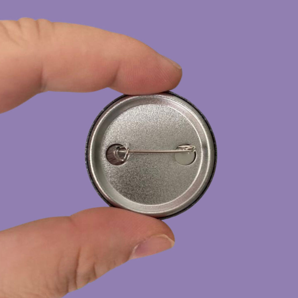 The reverse of a 38mm badge showing the fastening device.