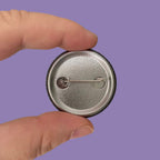 The reverse of a 38mm badge showing the fastening device.