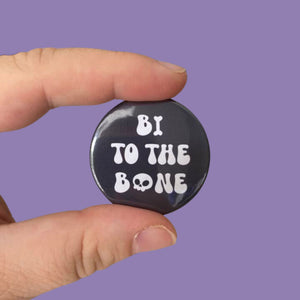 A black 38mm Badge with text reading 'Bi To The Bone' in white