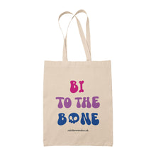 Load image into Gallery viewer, Natural cotton tote bag featuring the slogan Bi To The Bone in the colours of the bisexual flag