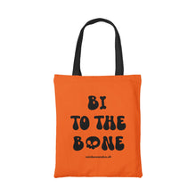 Load image into Gallery viewer, Orange cotton tote bag with a black handle featuring the slogan Bi To The Bone in blacktext