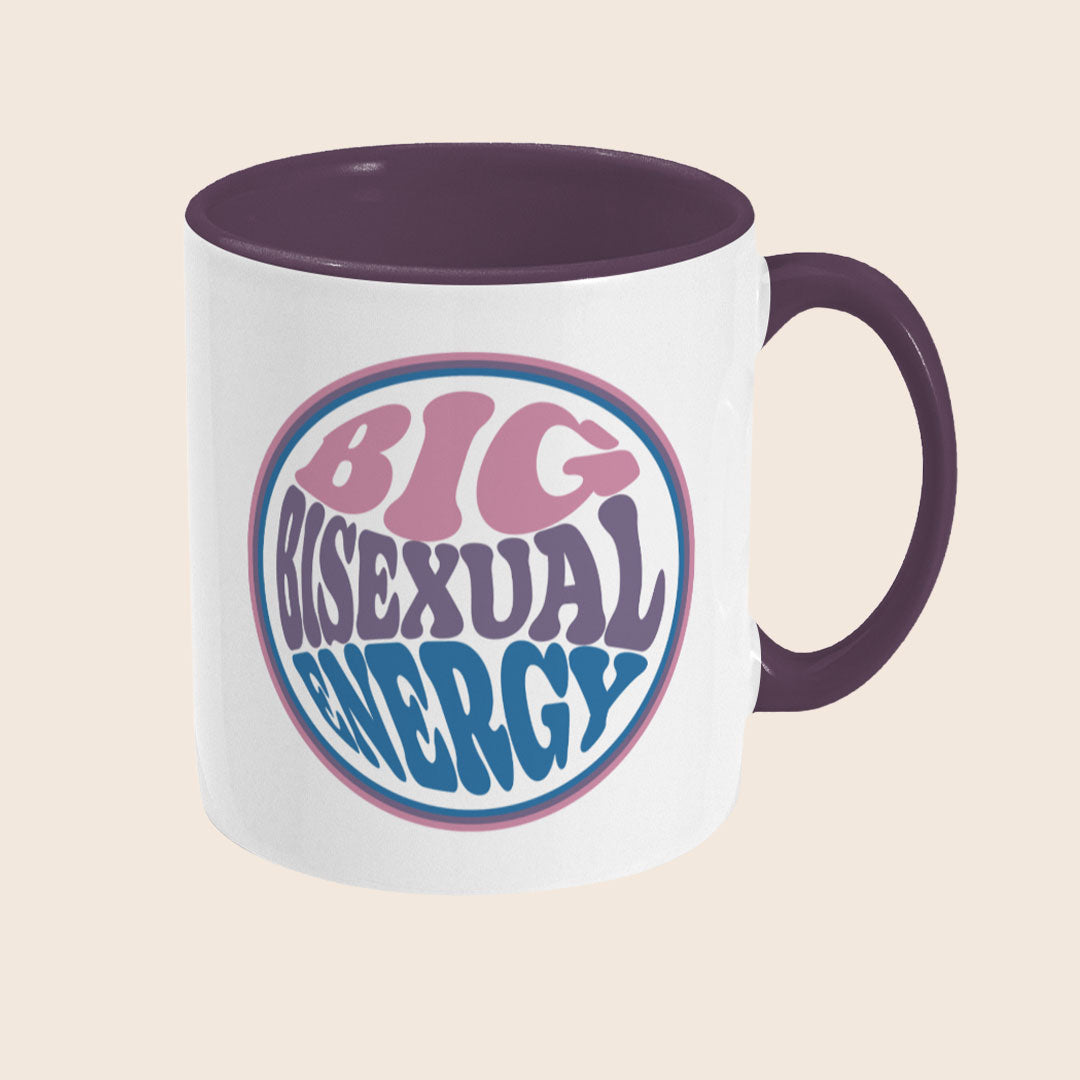 White mug with circular text reading “Big Bisexual Energy” in the colours of the bisexual flag (pink, purple, blue), inside a circular border.