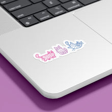 Load image into Gallery viewer, A laptop with a row of stickers featuring mummy-wrapped cats, displayed in the colours of the bisexual flag. The cats are shaded in pink, purple, and blue, placed on the bottom right of the laptop.