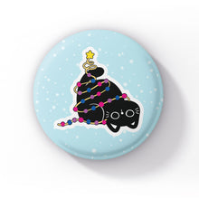 Load image into Gallery viewer, A black cat tangled in string lights in the colours of the bisexual flag (pink, purple, and blue), lying down on a light blue background with snowflakes.