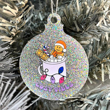Load image into Gallery viewer, Close up of a white Christmas tree displaying a silver glitter bauble featuring retro text reading &#39;cosy vibes&#39;. The image shows a mug of hot chocolate with marshmallows and a gingerbread man wearing a Santa hat. A candy cane in the mug and lights around the mug are the colours of the bisexual pride flag.