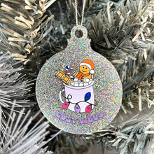 Load image into Gallery viewer, Close up of a white Christmas tree displaying a silver glitter bauble featuring retro text reading &#39;cosy vibes&#39;. The image shows a mug of hot chocolate with marshmallows and a gingerbread man wearing a Santa hat. A candy cane in the mug and lights around the mug are the colours of the bisexual pride flag.
