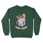Bottle Green sweatshirt featuring retro text reading 'cosy vibes'. The image shows a mug of hot chocolate with marshmallows and a gingerbread man wearing a Santa hat. A candy cane in the mug and lights around the mug are the colours of the bisexual pride flag.