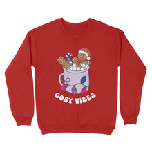 Load image into Gallery viewer, Fire Red sweatshirt featuring retro text reading &#39;cosy vibes&#39;. The image shows a mug of hot chocolate with marshmallows and a gingerbread man wearing a Santa hat. A candy cane in the mug and lights around the mug are the colours of the bisexual pride flag.