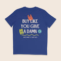 Back of a royal blue organic cotton t-shirt featuring the slogan "Buy Like You Give A Damn" with the message "Your Money Is Your Vote" and colourful illustrations celebrating conscious shopping.