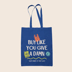 Royal blue cotton tote bag featuring the slogan "Buy Like You Give A Damn" alongside colourful illustrations and the words "Your Money Is Your Vote".
