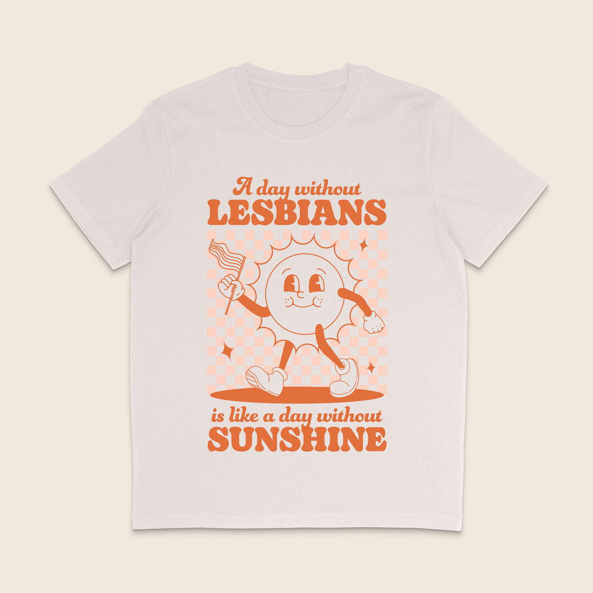 A vintage white short-sleeve crewneck t-shirt with a retro-style orange graphic on the front. The graphic features a cartoon sun character holding a flag and the text 'A day without LESBIANS is like a day without SUNSHINE'.