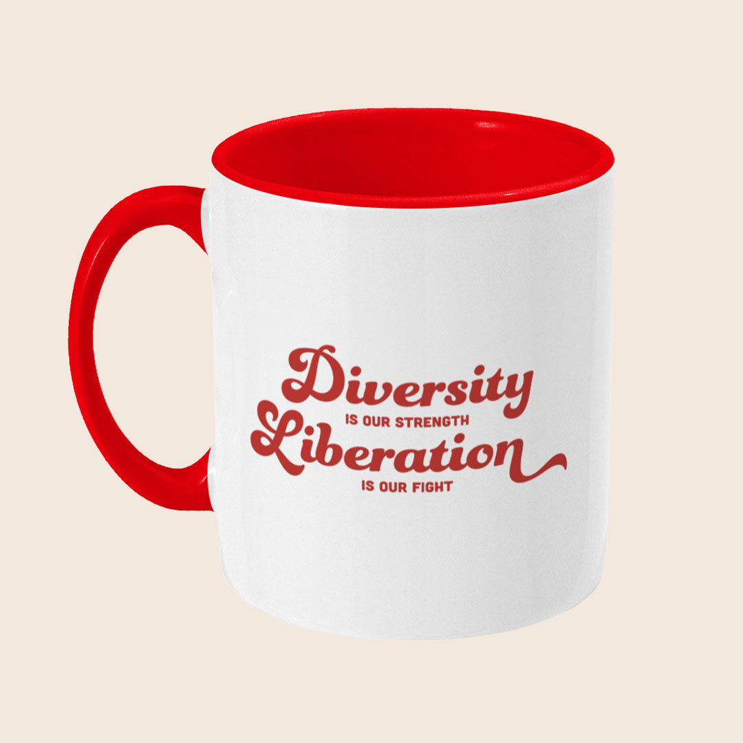 White ceramic mug with a red handle and red interior shown from a left angle, featuring the red text design reading “Diversity Is Our Strength, Liberation Is Our Fight”.