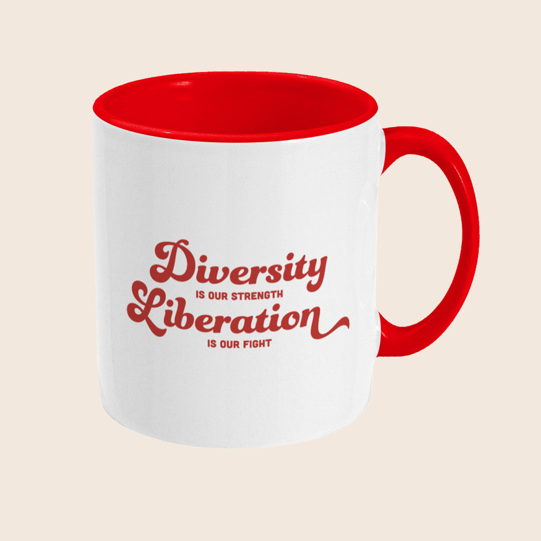 White ceramic mug with a red handle and red interior shown from a right angle, displaying the “Diversity Is Our Strength, Liberation Is Our Fight” design in red text.