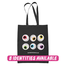 Load image into Gallery viewer, A black tote bag showcasing a collection of six cartoonish eyeballs arranged in two rows. Each eyeball has a unique colour: red, orange, yellow, green, blue, and purple. The text &quot;RAINBOWANDCO.UK&quot; is placed underneath the design, with a banner stating &quot;8 IDENTITIES AVAILABLE&quot;.