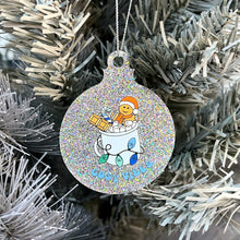 Load image into Gallery viewer, Close up of a white Christmas tree displaying a silver glitter bauble featuring retro text reading &#39;cosy vibes&#39;. The image shows a mug of hot chocolate with marshmallows and a gingerbread man wearing a Santa hat. A candy cane in the mug and lights around the mug are the colours of the gay pride flag.