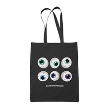 Load image into Gallery viewer, A black tote bag displaying six cartoonish eyeballs in two rows. The eyeballs are coloured in various shades of green and blue. The website &quot;RAINBOWANDCO.UK&quot; is written below the eyeballs.