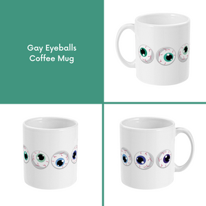 A composite image of a white coffee mug with a cartoon eyeball design in gay pride flag colours.