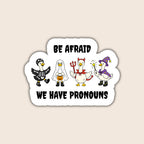 Be Afraid We Have Pronouns sticker featuring four geese dressed as a skeleton, ghost, devil and wizard on a beige background.