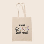 Natural cotton tote bag featuring four geese in Halloween costumes with the words Be Afraid We Have Pronouns