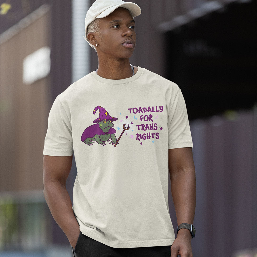 Model wearing a vintage white Toadally for Trans Rights T-shirt featuring a green wizard toad with a purple hat, cape and wand.