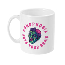 Load image into Gallery viewer, The left side of a white ceramic mug, showcasing a portion of the zombie-like face with pink text curving around the illustration, reading &quot;HOMOPHOBIA ROTS YOUR BRAIN.&quot;