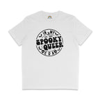 A white T-shirt with the phrase "In My Spooky Queer Era" printed in bold, dripping black letters, surrounded by bat and skull illustrations, giving a Halloween-themed look. The shirt is laid flat on a white background.