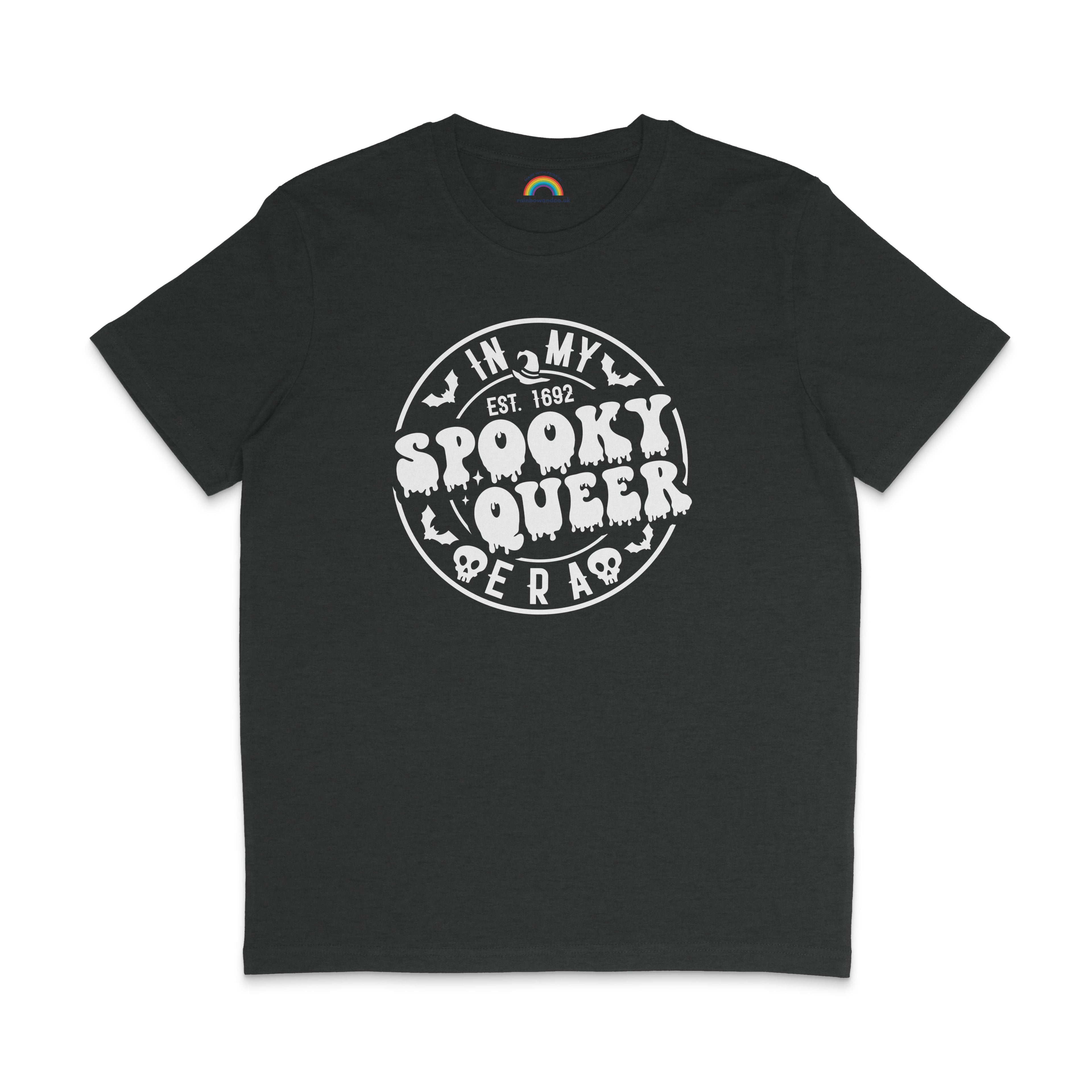 A dark heather grey T-shirt featuring the same "In My Spooky Queer Era" design in white, with dripping letters and Halloween-themed illustrations. The shirt is laid flat on a matching dark background.