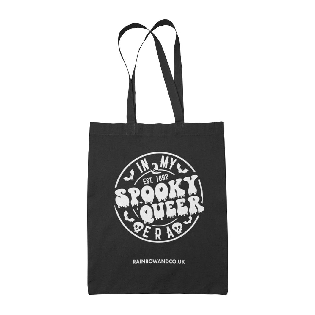 A black tote bag featuring a white circular design with the text 