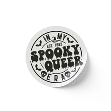 Load image into Gallery viewer, A round white sticker with black text that reads &quot;In My Spooky Queer Era EST. 1692.&quot; The design features dripping letters, bats, and skulls, giving a spooky, Halloween-themed appearance.