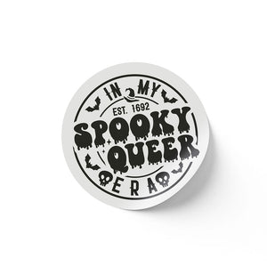 A round white sticker with black text that reads "In My Spooky Queer Era EST. 1692." The design features dripping letters, bats, and skulls, giving a spooky, Halloween-themed appearance.