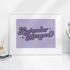 A framed Lavender Menace print styled on a sleek white desk. The subtle lavender tones and vintage-inspired typography bring a touch of LGBTQ+ pride to any space.
