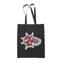 Load image into Gallery viewer, A black tote bag featuring a cute cartoon spider in front of a spider web coloured in the lesbian pride flag colours: pink, white, and orange.